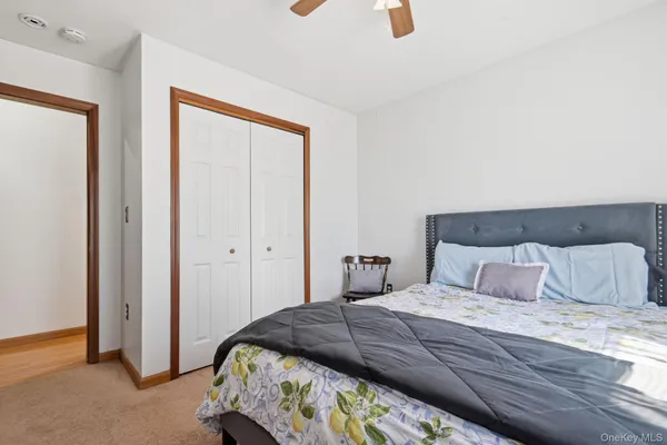 a bedroom with a bed and painting on the wall