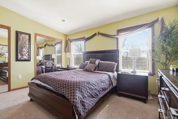 a bedroom with a bed wooden floor and window