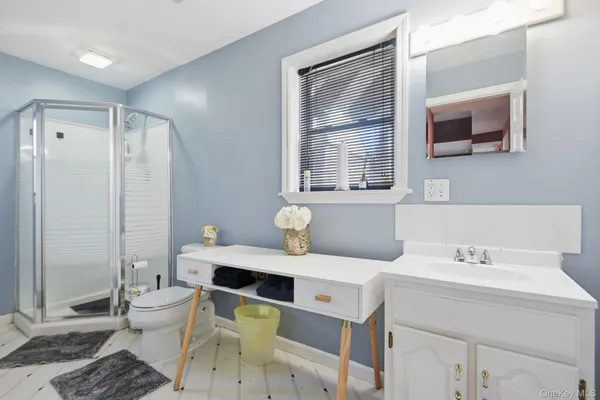 a bathroom with a sink toilet and shower