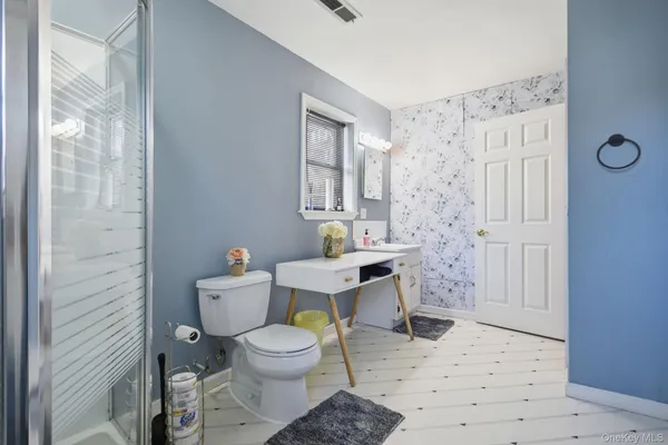 a bathroom with a toilet a sink and a shower
