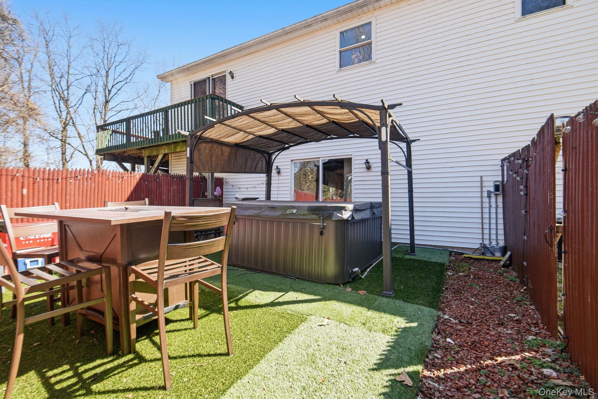 25 De Garmo Road Poughkeepsie, NY 12603 - Photo 49 of 50 a view of a patio with table and chairs with wooden fence