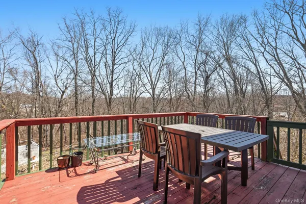 a view of a chairs and table on the deck