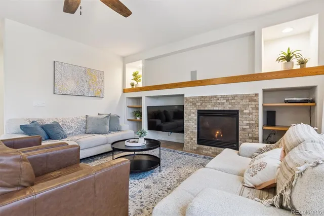 a living room with furniture and a fireplace