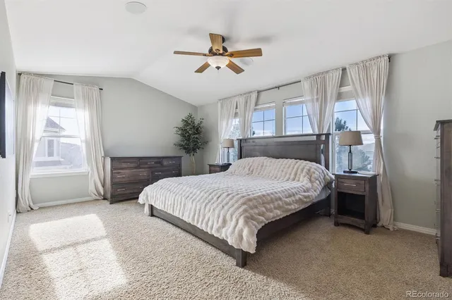 a bedroom with a bed a dresser and a window