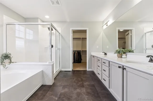 a bathroom with a double vanity sink and a bathtub