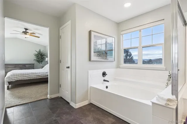 a bathroom with a tub and a view of bathroom