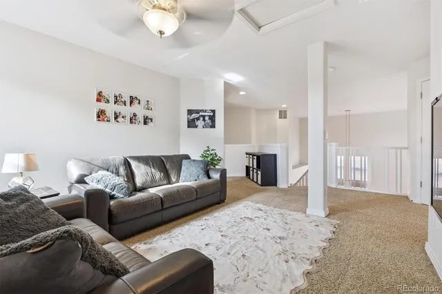 a living room with furniture a couch and a chandelier