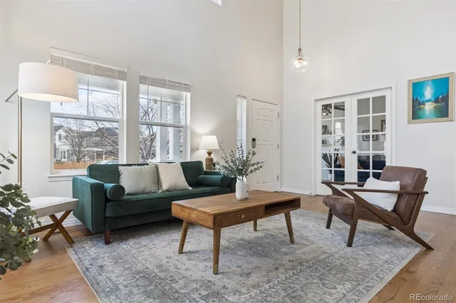 a living room with furniture and a potted plant