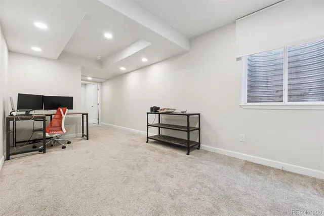 a view of work space with furniture and windows