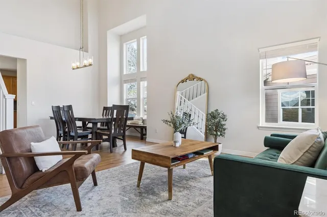 a living room with furniture a rug and a large window