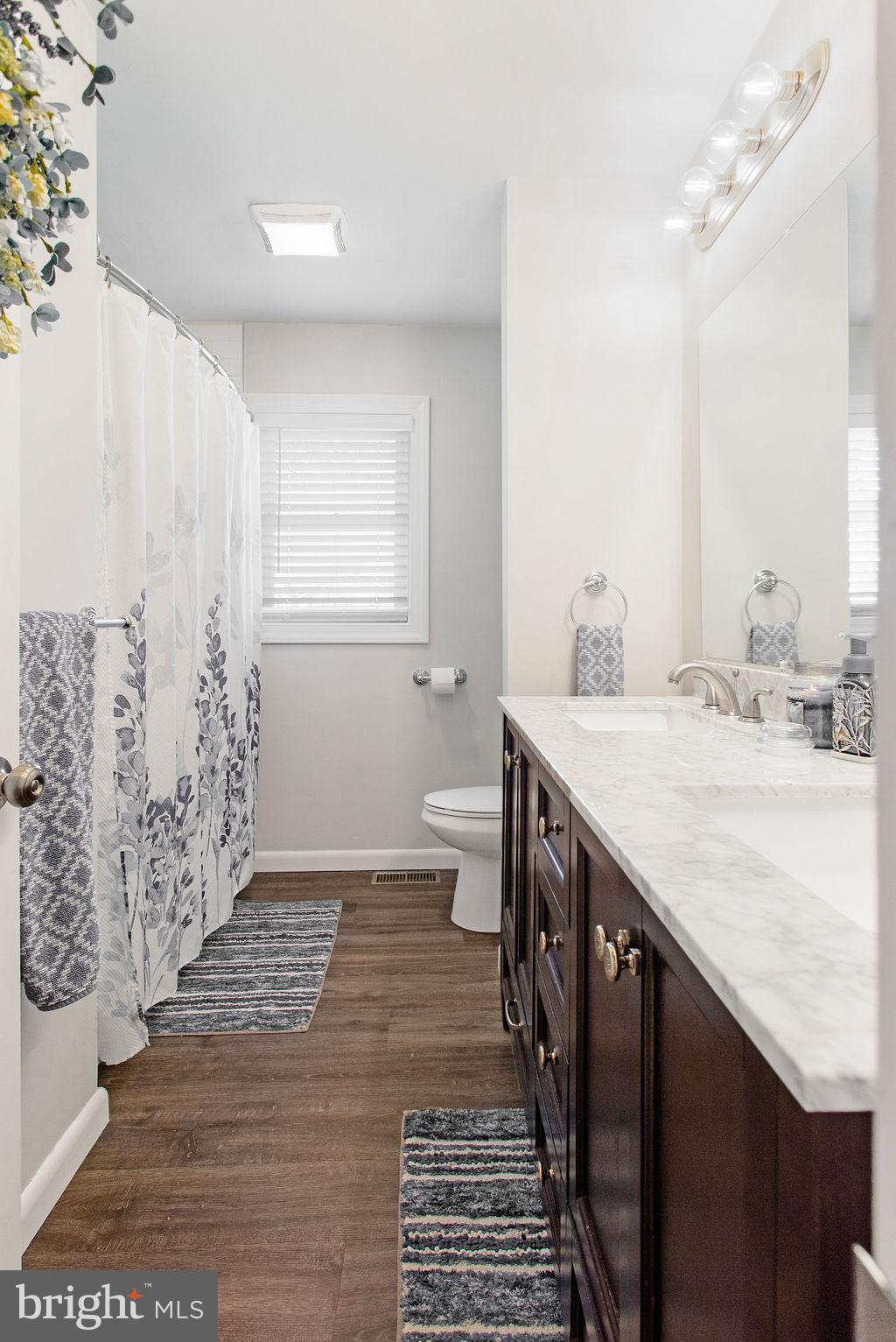 2970 Baltimore Pike Hanover, PA 17331 - Photo 20 of 30 a bathroom with a sink a toilet a mirror and shower