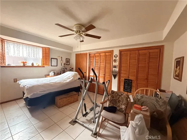 a bedroom with furniture and large windows
