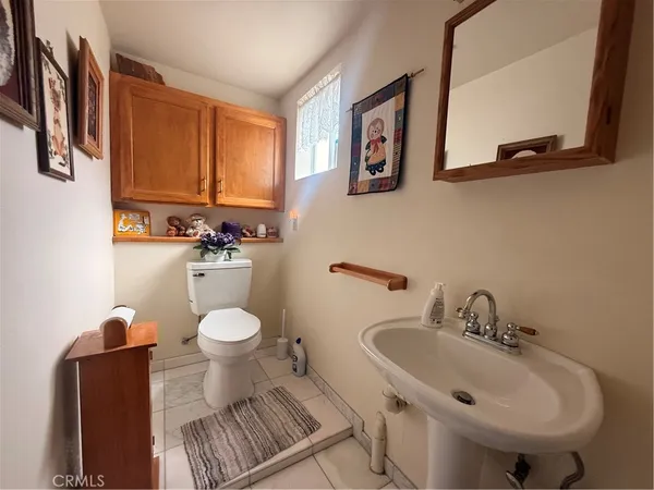 a bathroom with a sink toilet and a mirror