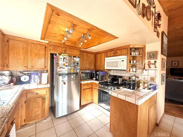 a kitchen with stainless steel appliances kitchen island granite countertop a stove and a refrigerator