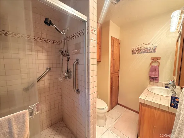 a bathroom with a granite countertop shower and a sink