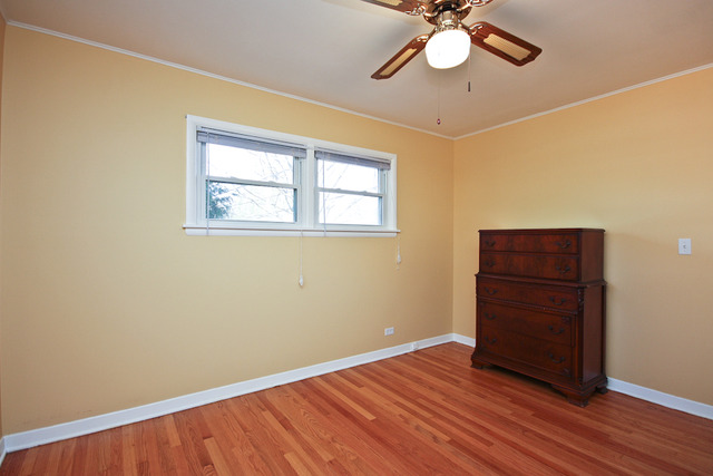 557 Sumac Road Highland Park, IL 60035 - Photo 10 of 20 a view of an empty room with wooden floor and a window