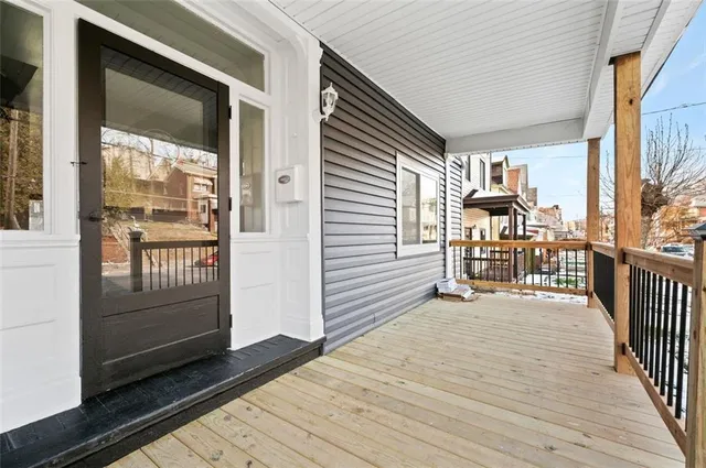 a view of a balcony with wooden floor