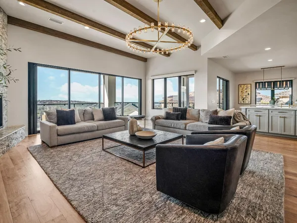 a view of a patio with couches and table and chairs and potted plants