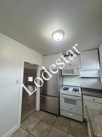 a kitchen with a stove and a refrigerator