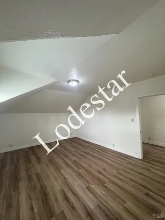 a view of room that has wooden floor
