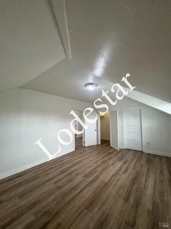 a view of a room with wooden floor
