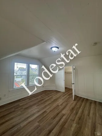 a view of a room with wooden floor and staircase