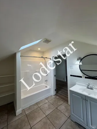 a bathroom with a mirror and a sink