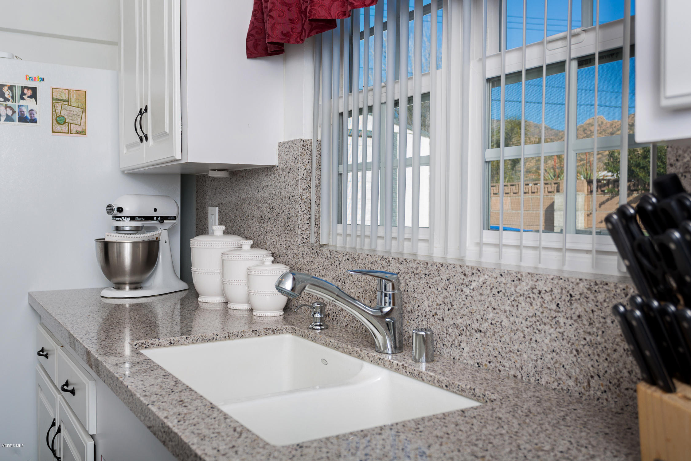 6295 Caroline Avenue Simi Valley, CA 93063 - Photo 12 of 27 a kitchen with granite countertop a sink a stove and a cabinets