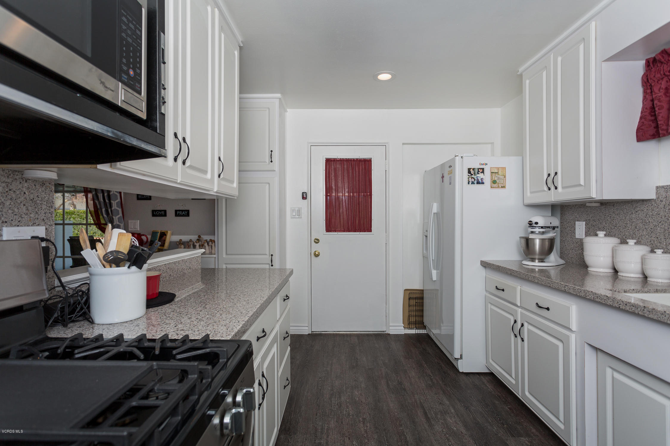 6295 Caroline Avenue Simi Valley, CA 93063 - Photo 13 of 27 a kitchen with a stove and white cabinets