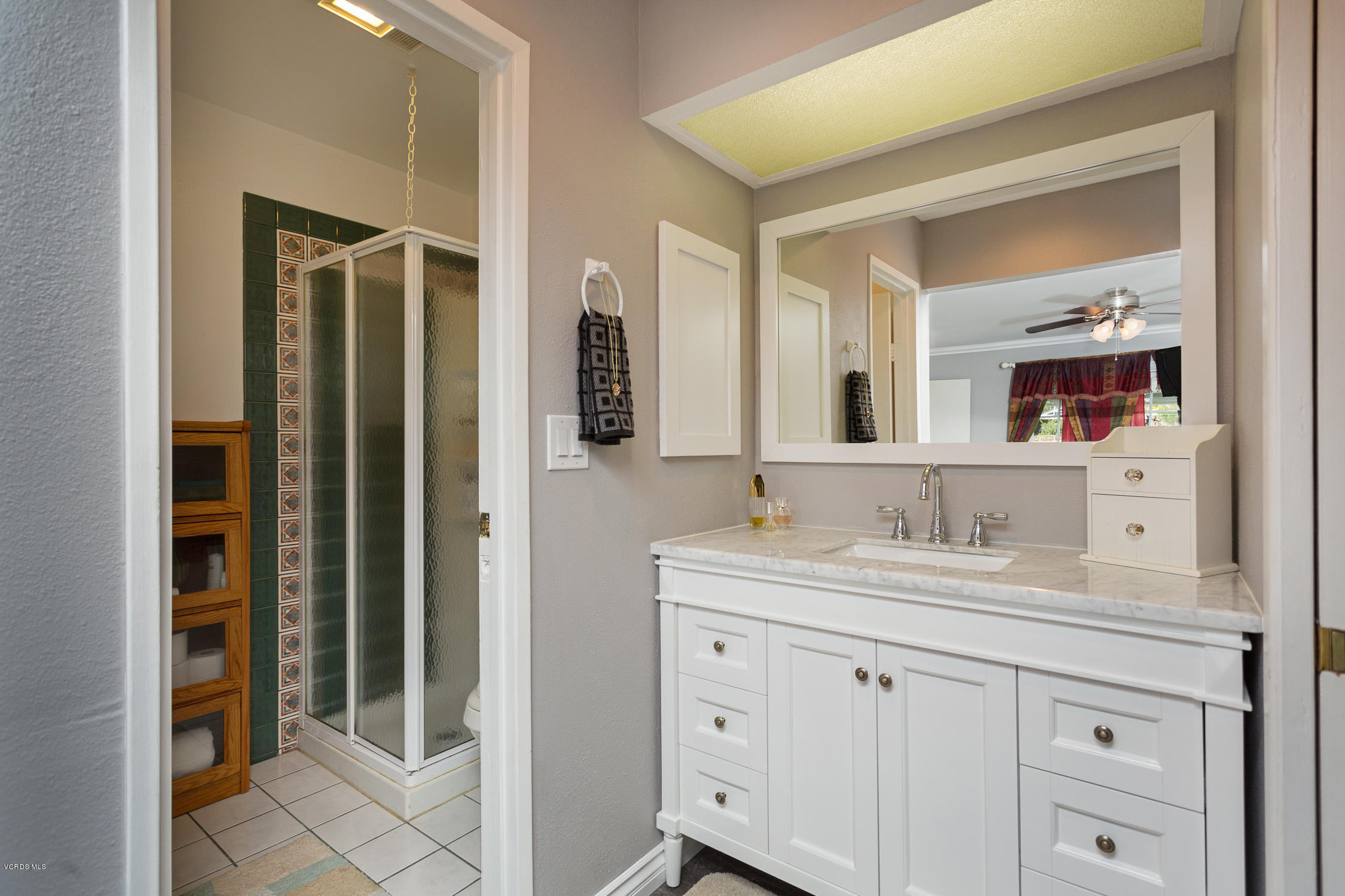6295 Caroline Avenue Simi Valley, CA 93063 - Photo 17 of 27 a bathroom with a double vanity sink and mirror