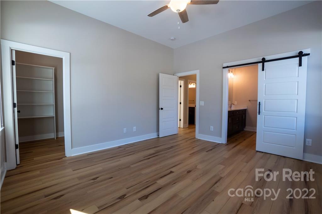 309 Houston Street, Unit B Davidson, NC 28036 - Photo 8 of 15 wooden floor in an empty room with a bathroom