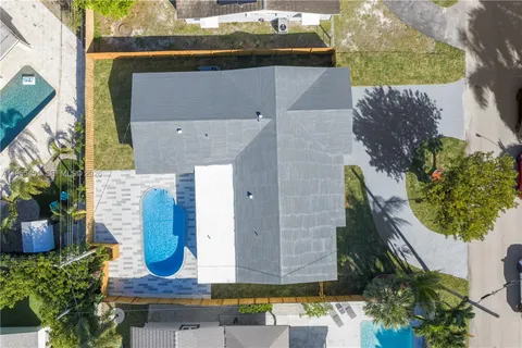 an aerial view of residential houses with outdoor space and street view