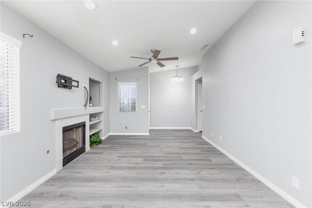 2254 Ramsgate Drive Henderson, NV 89074 - Photo 5 of 43 A spacious living area features elegant flooring, an inviting fireplace, and a versatile layout.