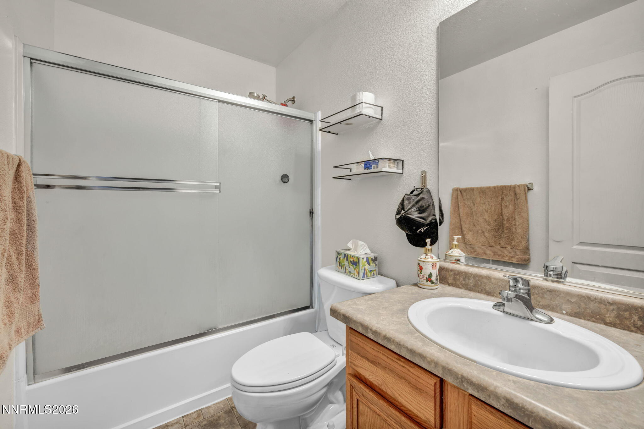 17615 Baileyville Court Reno, NV 89508 - Photo 15 of 19 a bathroom with a granite countertop sink toilet and shower