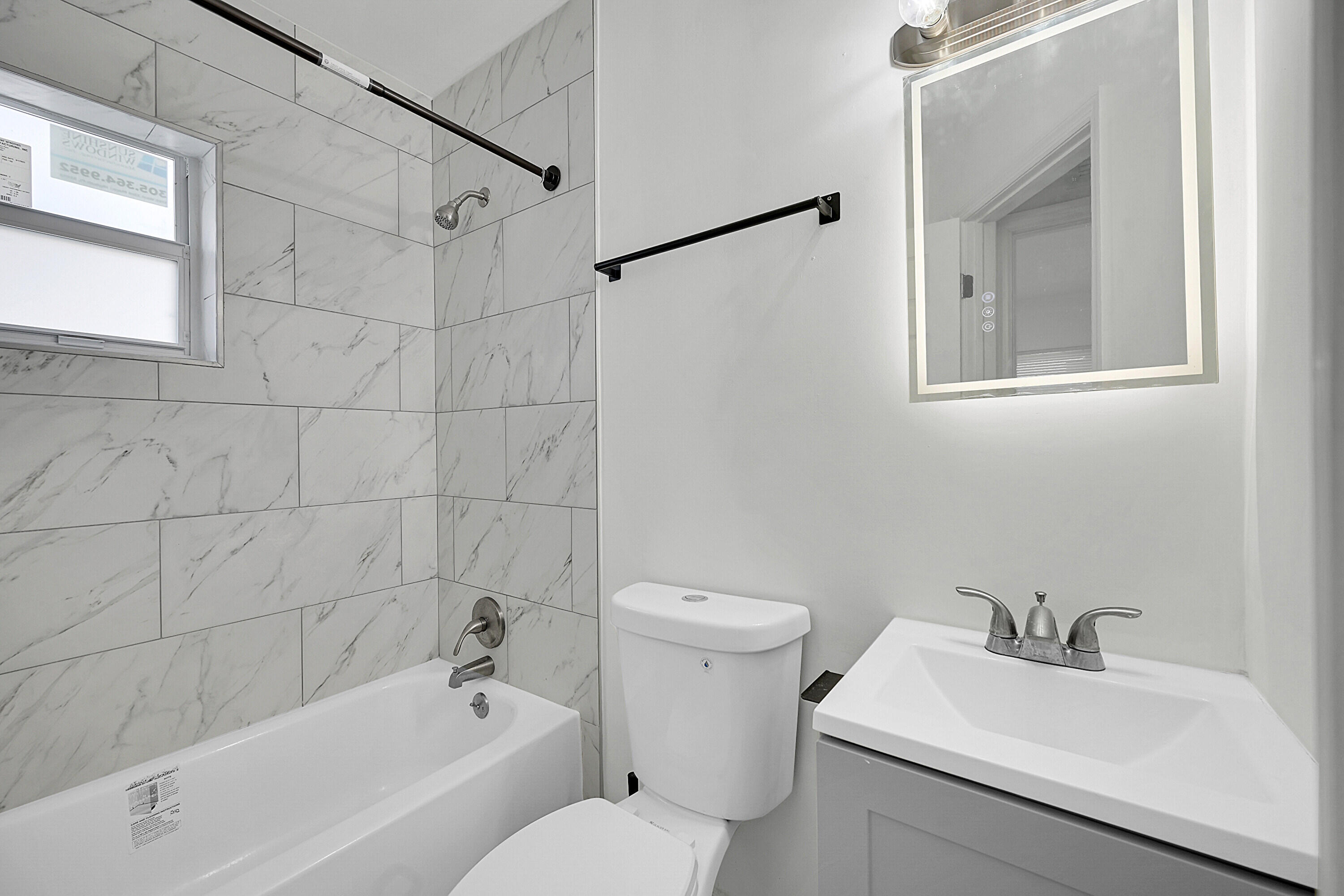 1157 West 36th Street, Unit 1 Riviera Beach, FL 33404 - Photo 8 of 12 a bathroom with a sink toilet and shower