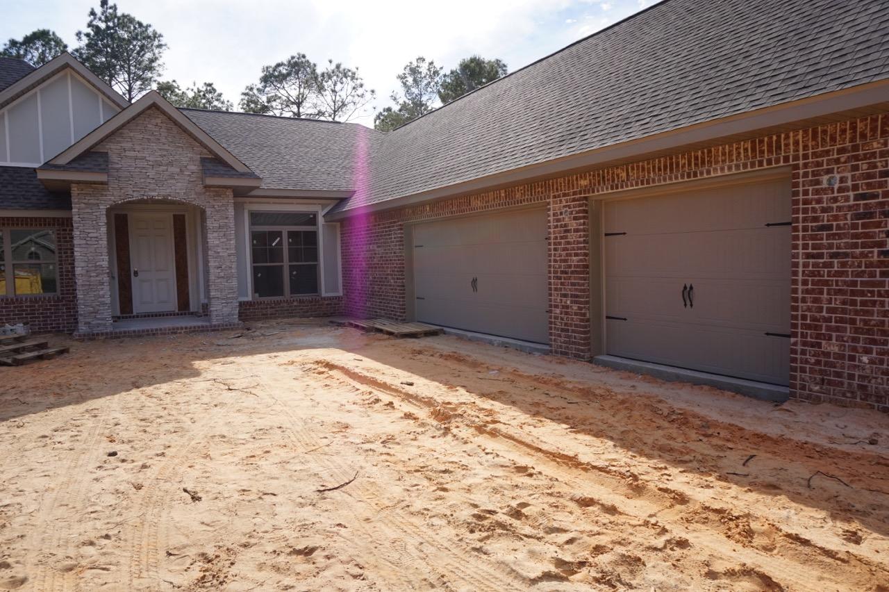 2585 Cove Road Navarre, FL 32566 - Photo 23 of 47 a view of garage with a barn in front of it