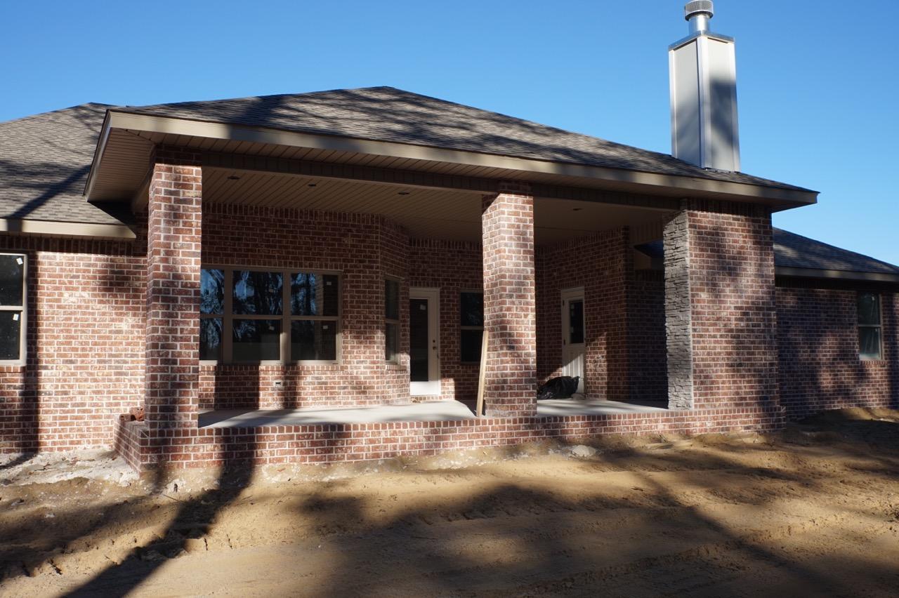 2585 Cove Road Navarre, FL 32566 - Photo 26 of 47 a front view of a house with a garden
