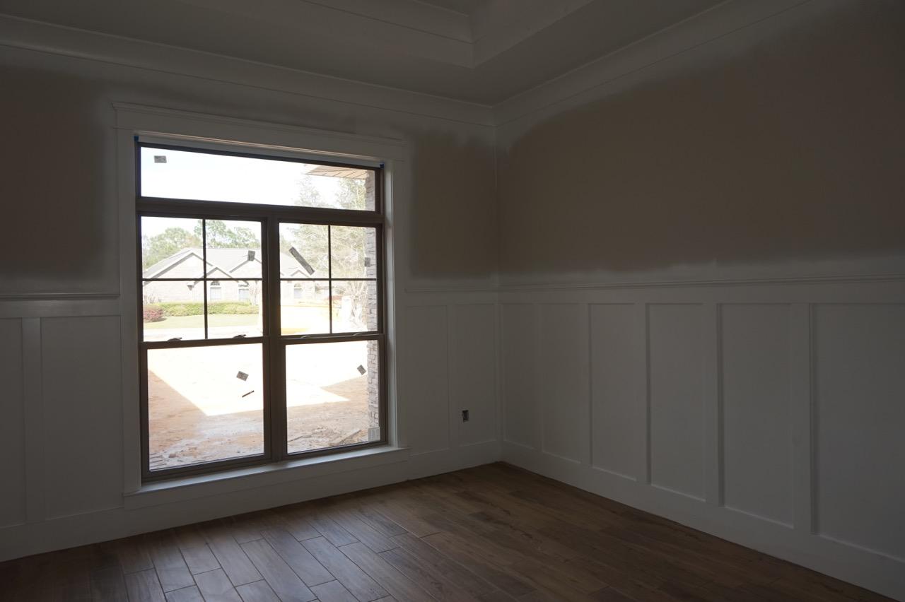 2585 Cove Road Navarre, FL 32566 - Photo 36 of 47 an empty room with wooden floor and windows