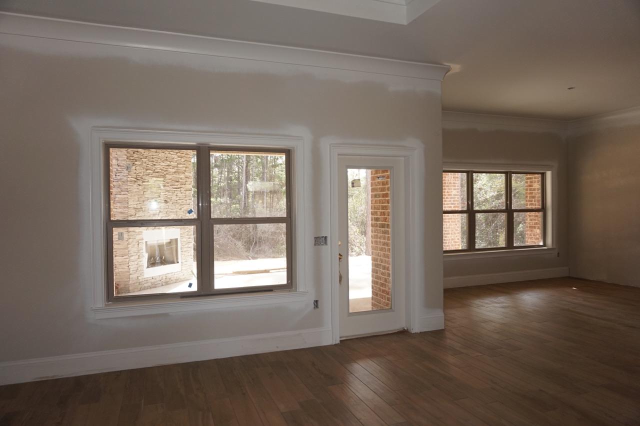 2585 Cove Road Navarre, FL 32566 - Photo 42 of 47 a view of an empty room with wooden floor and a window