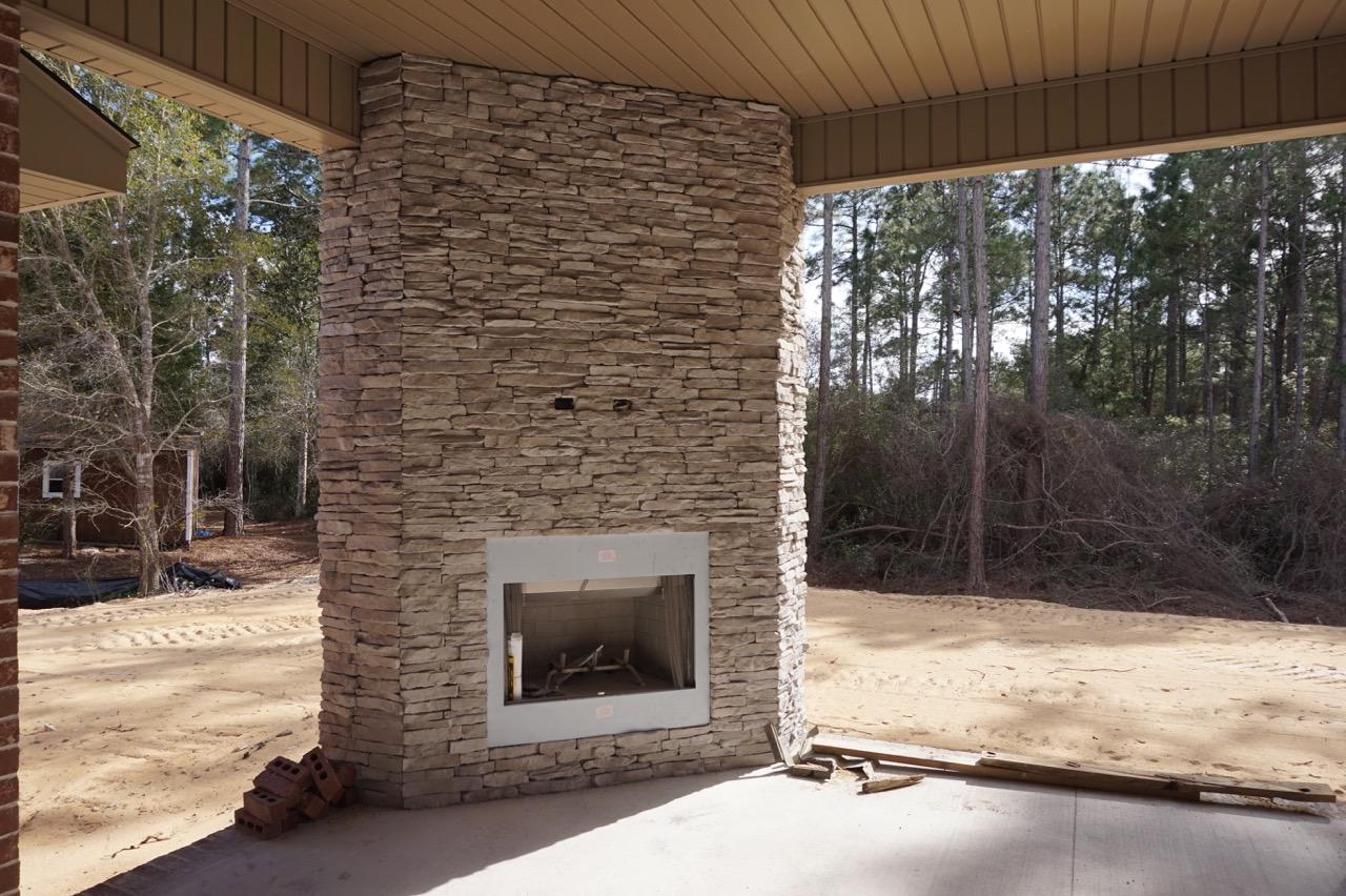 2585 Cove Road Navarre, FL 32566 - Photo 47 of 47 a stone house with trees in front of it