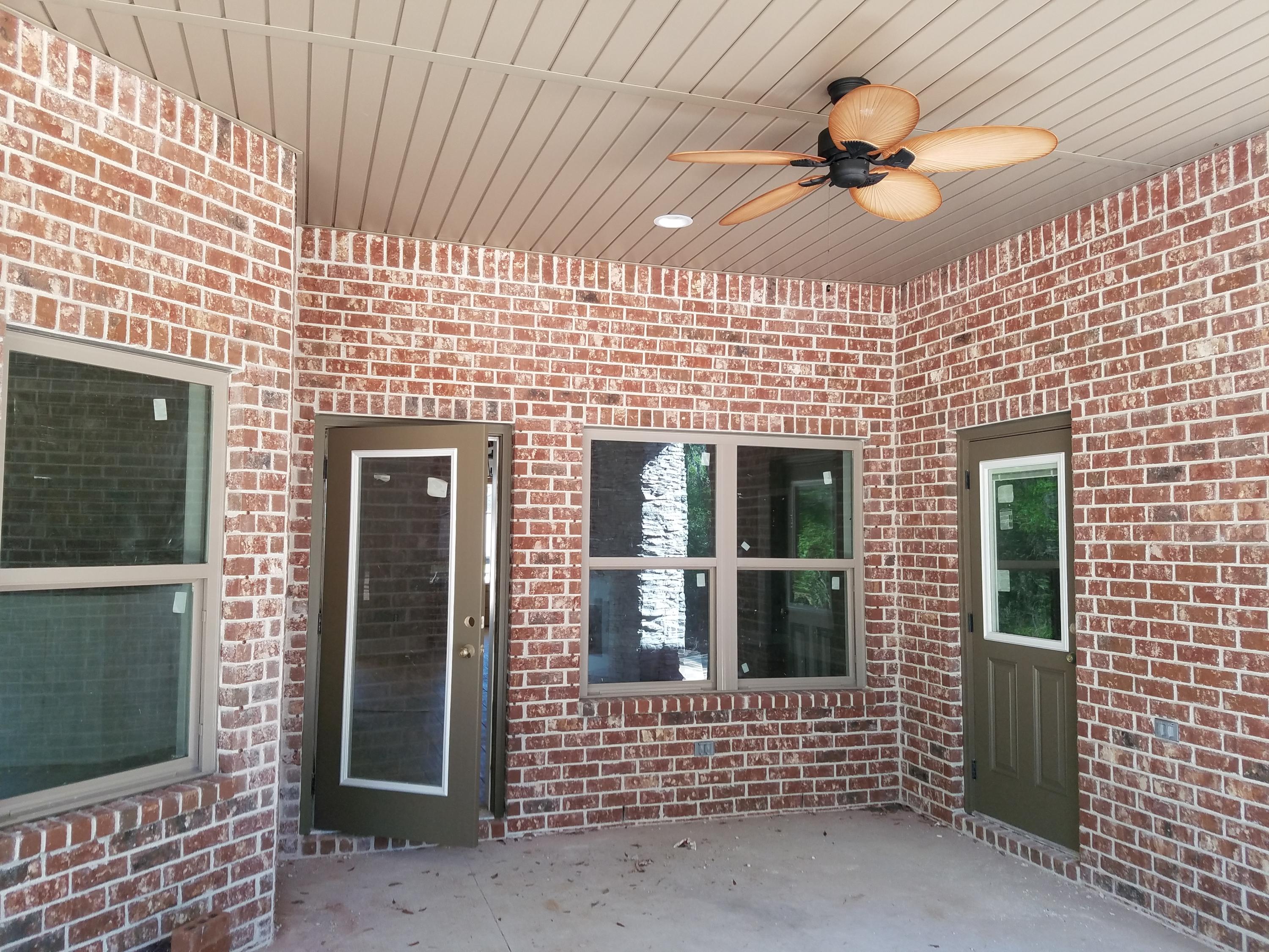 2585 Cove Road Navarre, FL 32566 - Photo 8 of 47 a front view of a house with a glass door