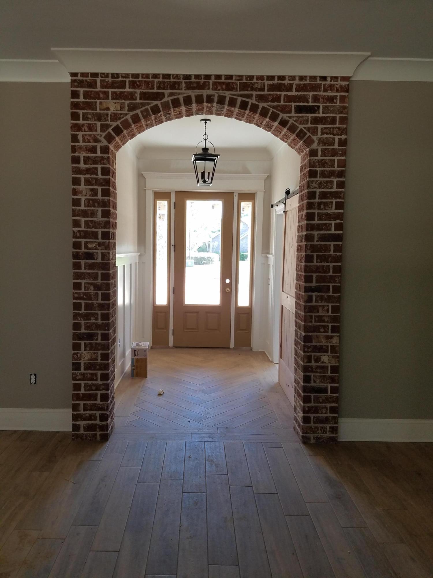 2585 Cove Road Navarre, FL 32566 - Photo 9 of 47 an empty room with wooden floor and windows