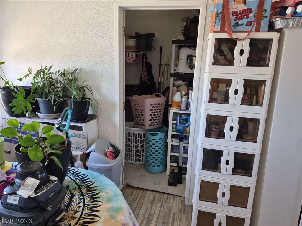 2271 Tough Boy Road Pahrump, NV 89060 - Photo 7 of 12 An organized laundry area with shelving provides ample storage and utility.
