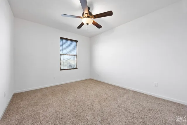 an empty room with fan and entrance