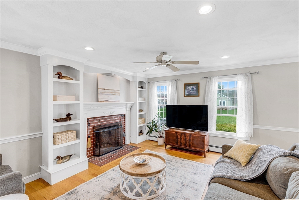 54 Old Merrill Street Amesbury, MA 01913 - Photo 5 of 34 a living room with furniture a flat screen tv and a fireplace