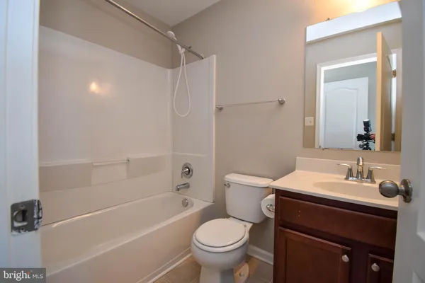 a bathroom with a sink toilet vanity and shower
