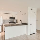 a kitchen with stainless steel appliances a refrigerator and a stove top oven