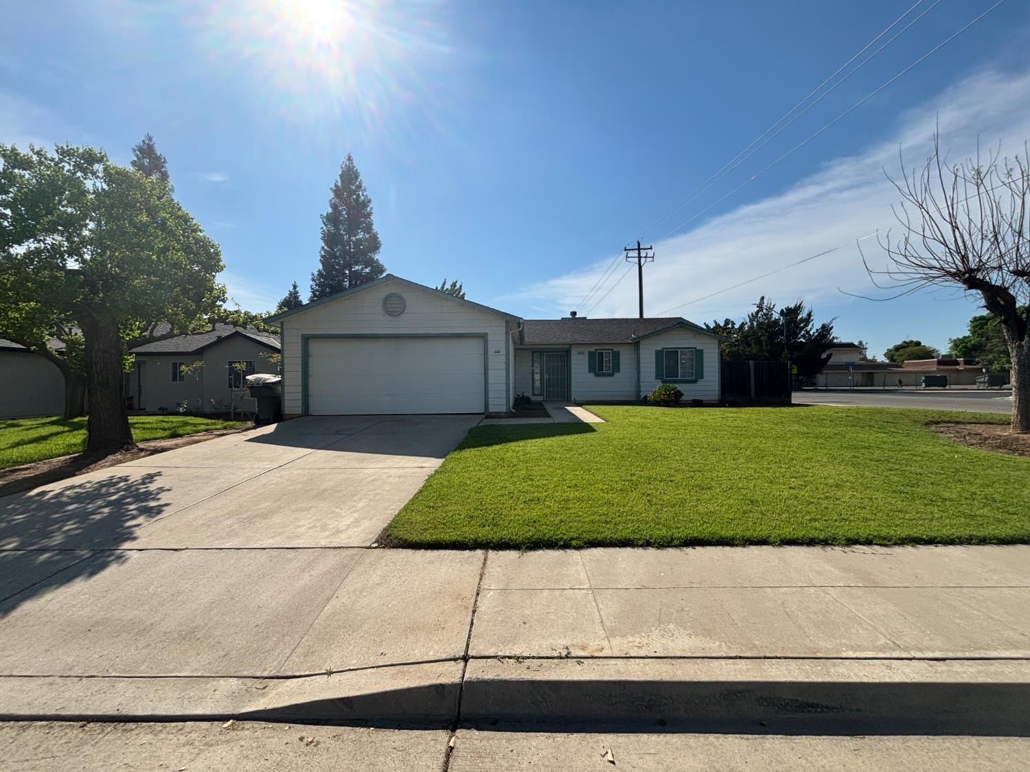 813 Morton Avenue Sanger, CA 93657 - Photo 1 of 19 a front view of a house with a garden and yard