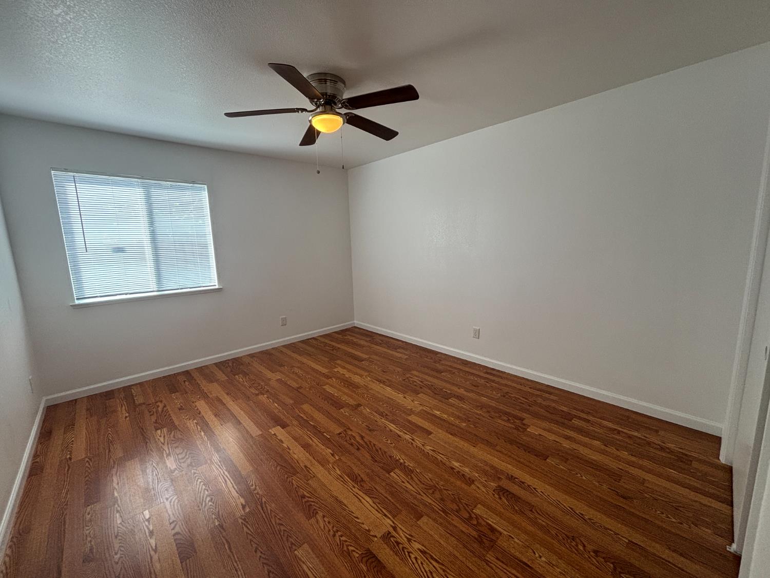 813 Morton Avenue Sanger, CA 93657 - Photo 12 of 19 a view of empty room with wooden floor