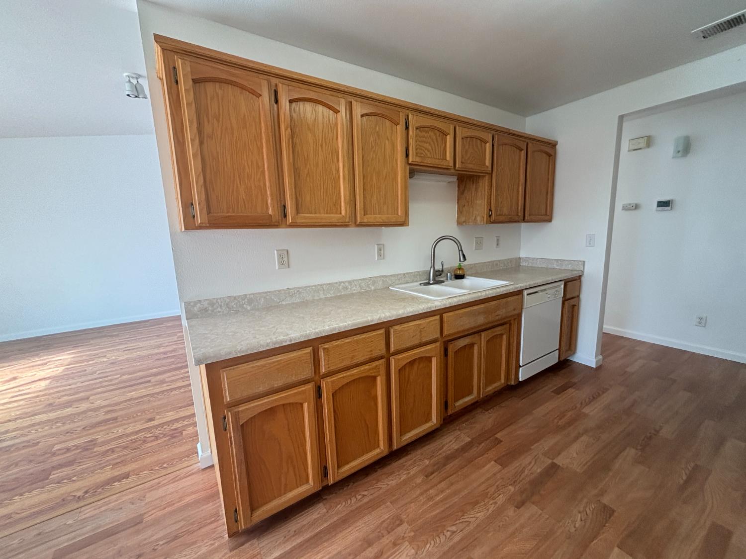 813 Morton Avenue Sanger, CA 93657 - Photo 5 of 19 a kitchen with a sink a cabinets and wooden floor